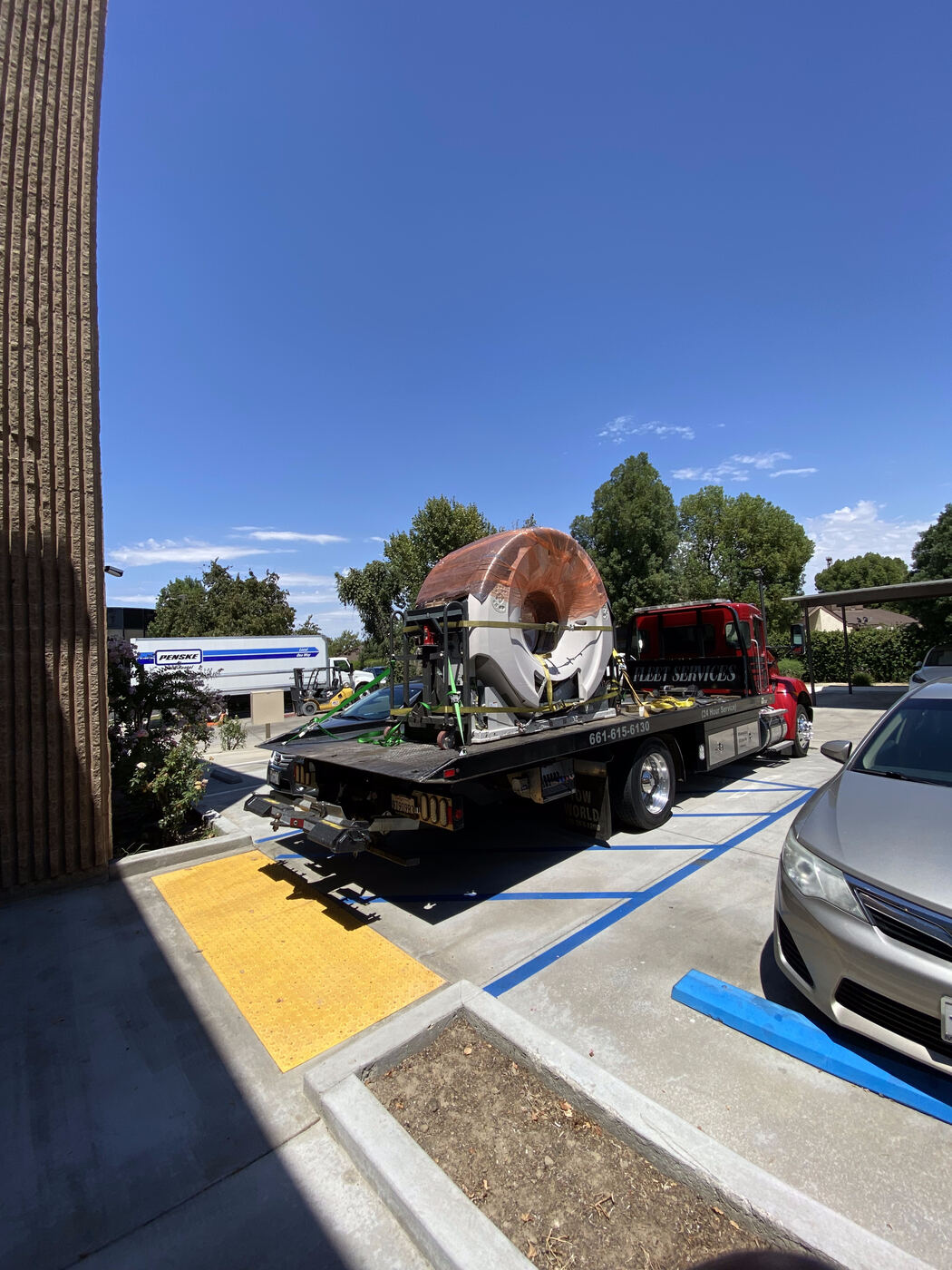 CT scanner strapped to a flatbed truck for transport