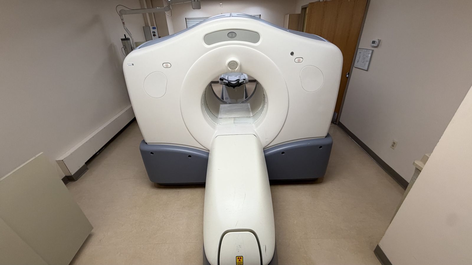 Head-on view of the GE Discovery PET/CT gantry and patient table before teardown